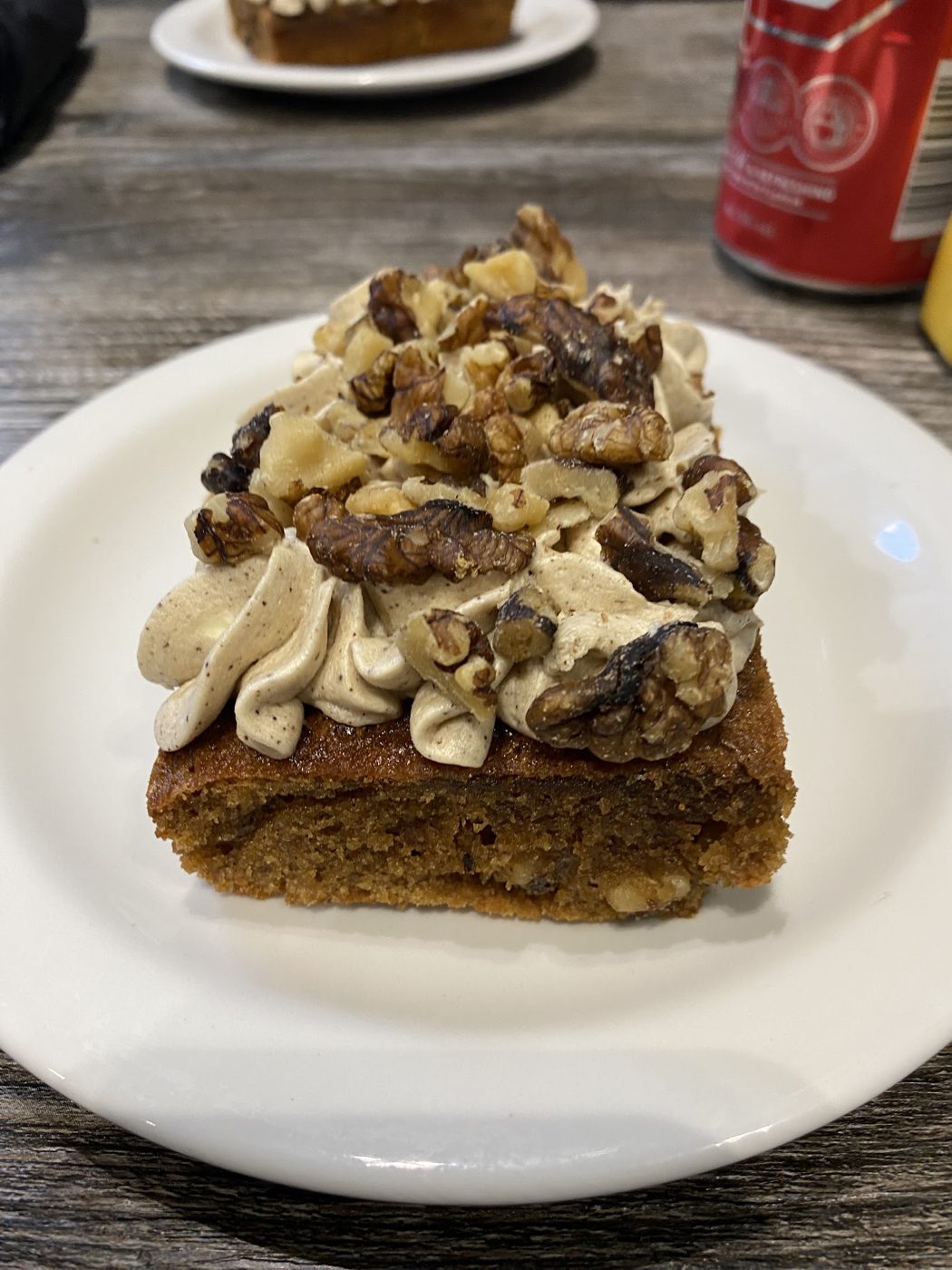 A slice of cake topped with cream and chocolate